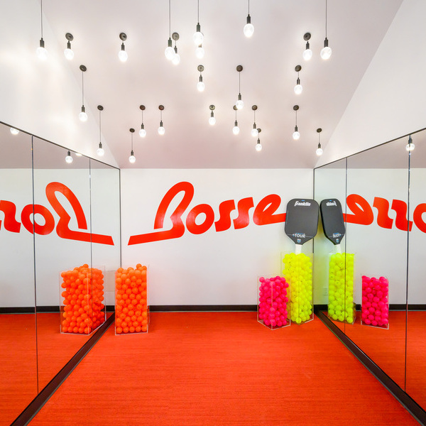 Small exercise room with mirror on the walls and red carpet